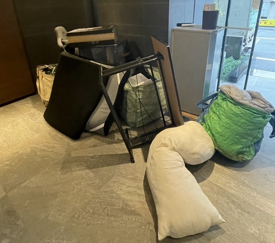 西区高島での回収前｜マンションのエントランスに集めたソファのクッションとハンガーラック、小型冷蔵庫